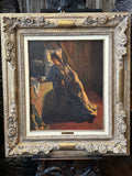 An oil painting of a woman in a dark dress seated indoors, housed in an ornate carved gold frame.
