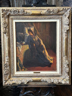 An oil painting of a woman in a dark dress seated indoors, housed in an ornate carved gold frame.
