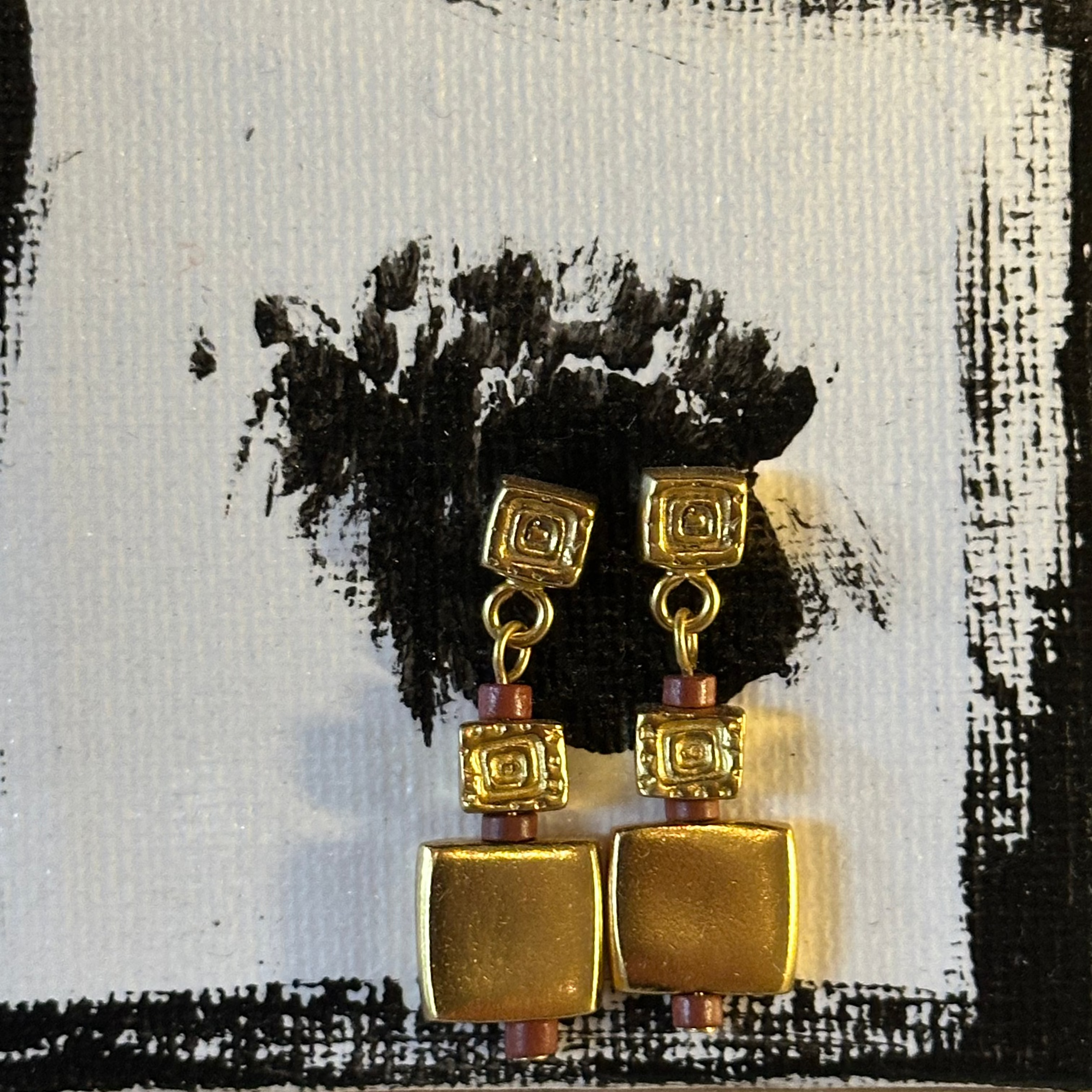 drop earrings with square geometric charms and small reddish-brown beads